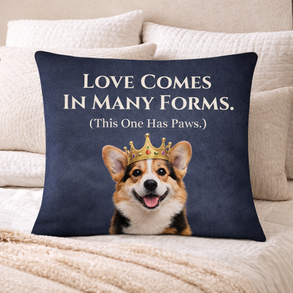 Navy blue pillow with a corgi wearing a crown and text 'Love comes in many forms. (This one has paws).'