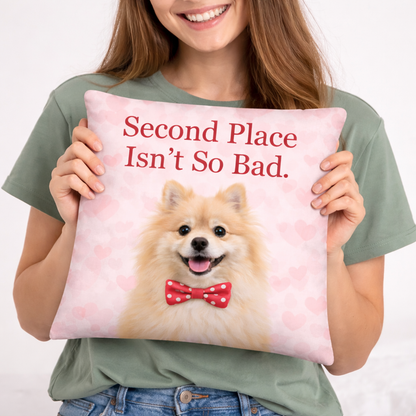 Person holding a pillow with a dog and text 'Second Place Isn't So Bad' on a light background