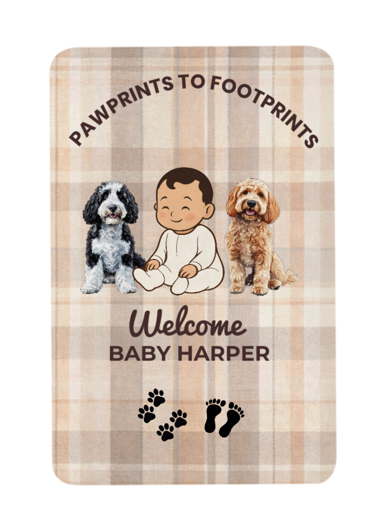 Personalized baby blanket with two dogs and a baby illustration on a plaid background.