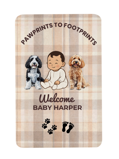 Personalized baby blanket with two dogs and a baby illustration on a plaid background.