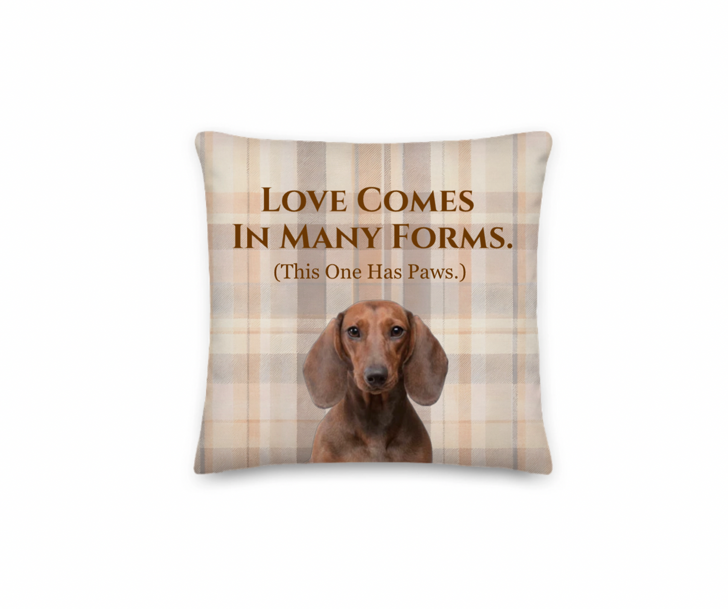 Pillow with a dachshund and text 'Love comes in many forms. (This one has paws.)' on a plaid background