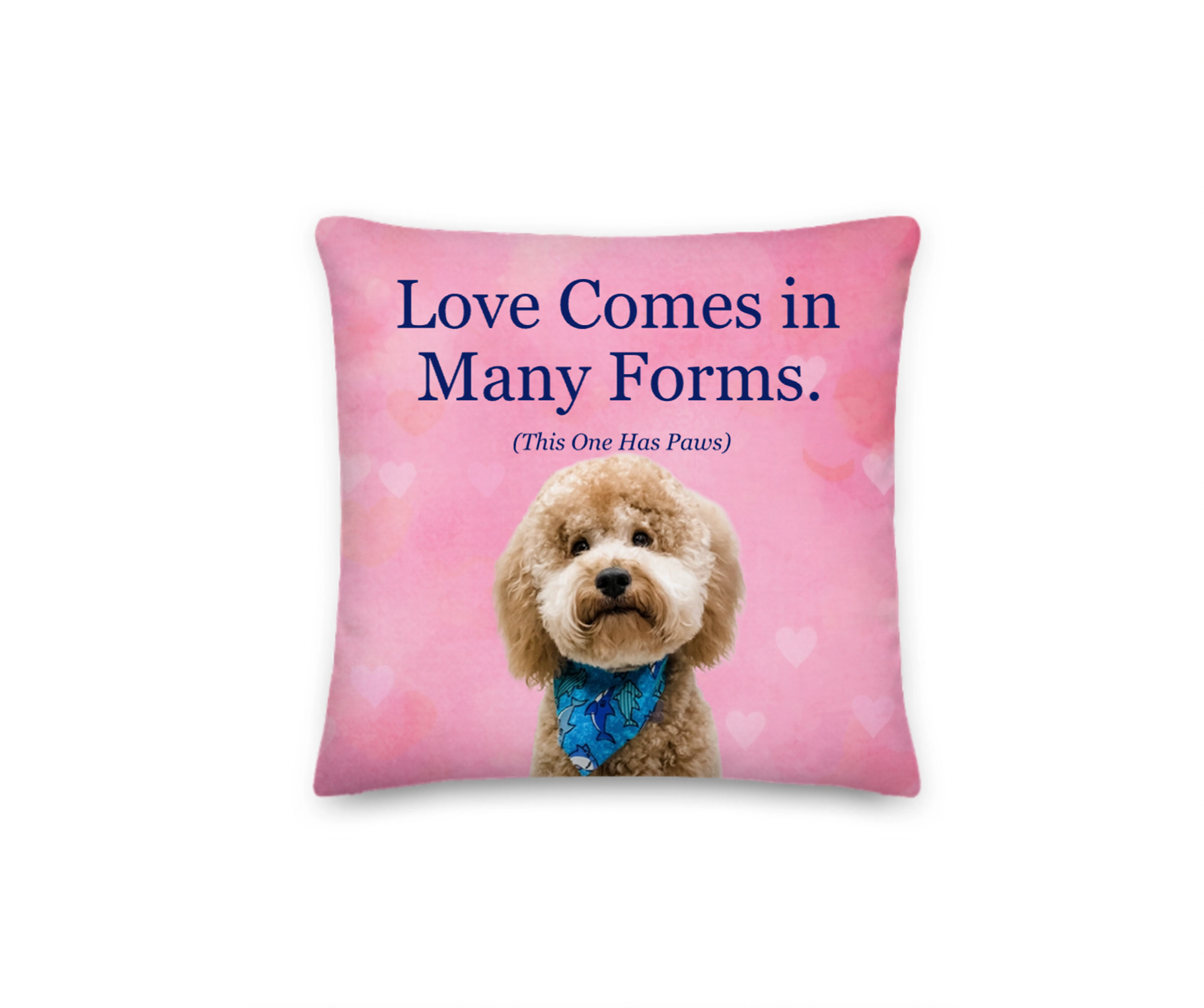 Pillow with a dog and text 'Love Comes in Many Forms. (This One Has Paws)' on a pink background