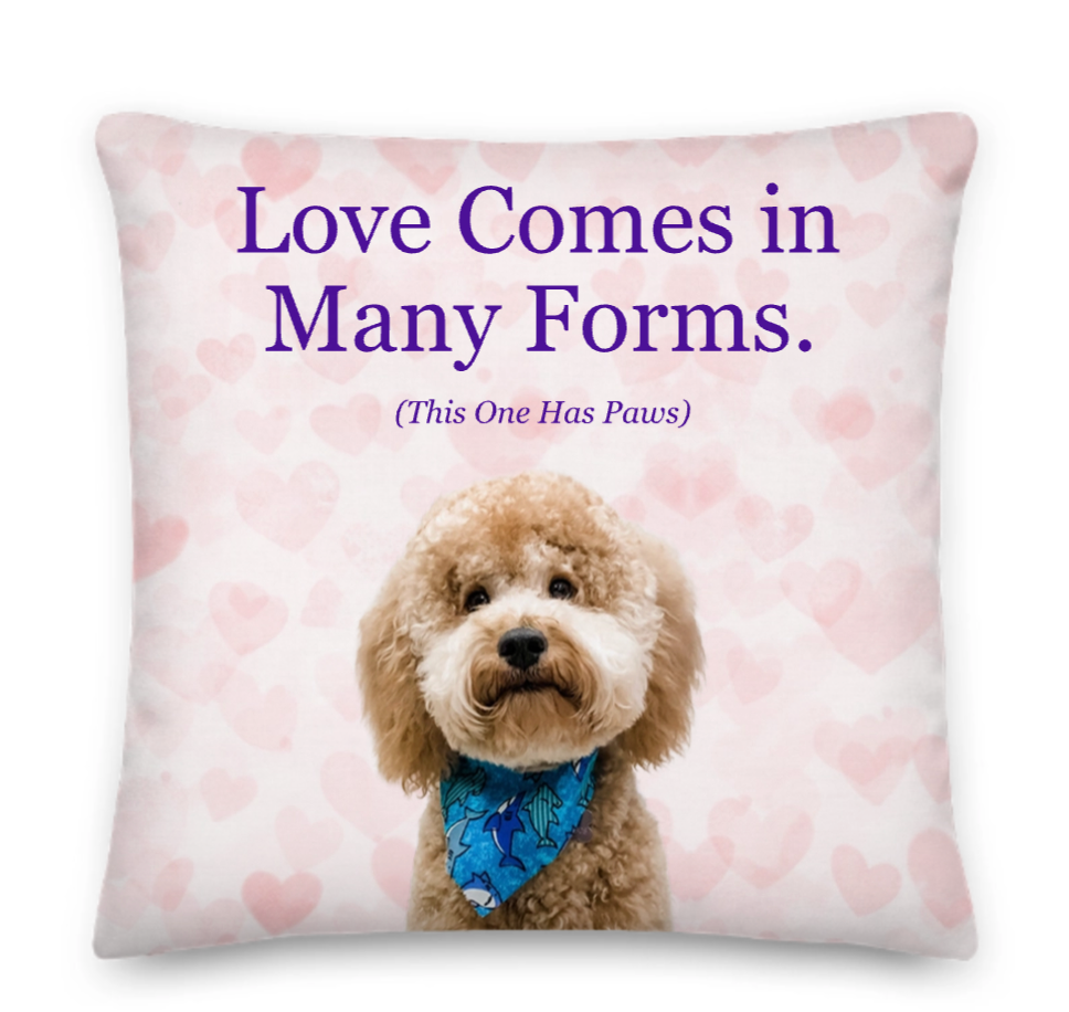 Pillow with a dog and text 'Love Comes in Many Forms. (This One Has Paws)' on a heart-patterned background