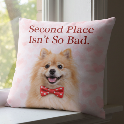 Pillow with a dog wearing a bow tie and text 'Second Place Isn't So Bad' on a pink background.