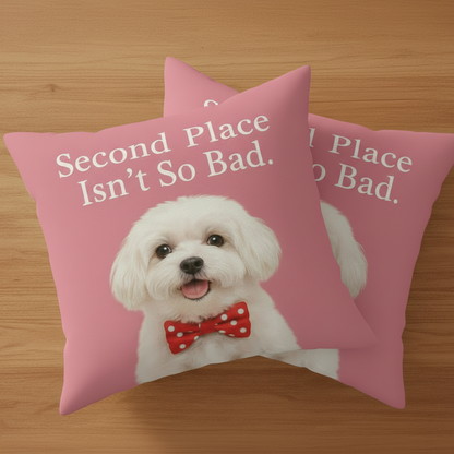 Pillow with a dog wearing a red bow tie and text 'Second Place Isn't So Bad' on a pink background