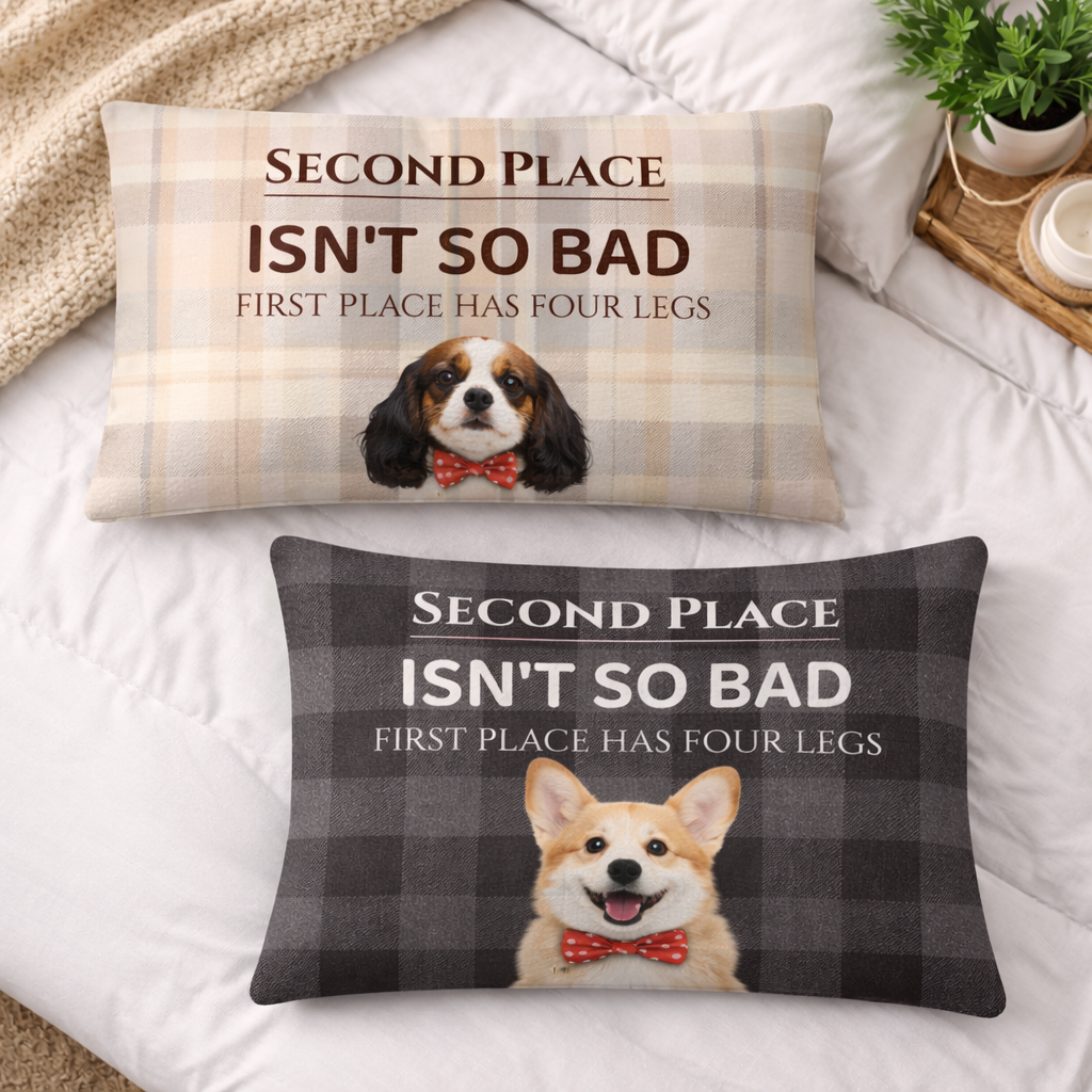 Two decorative pillows with dog illustrations and humorous text on a bed.
