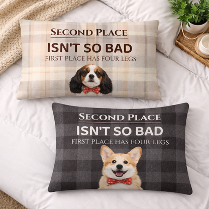 Two decorative pillows with dog illustrations and humorous text on a bed.