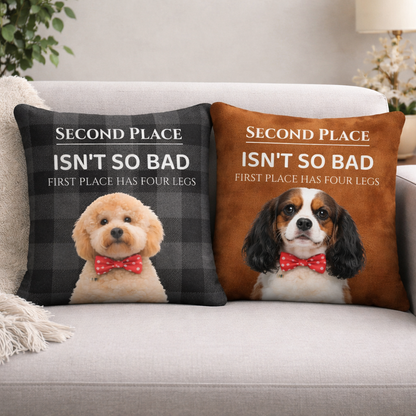 Two decorative pillows with dogs and humorous text on a couch.