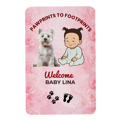 Baby announcement blanket with a dog and baby illustration on a pink floral background.