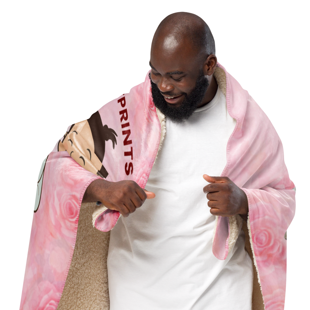 Man holding a pink blanket with cartoon character and text on a white background
