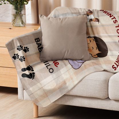 Sofa with a blanket featuring cartoon characters and text, next to a wooden coffee table.