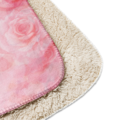 Close-up of a pink and beige bath mat corner