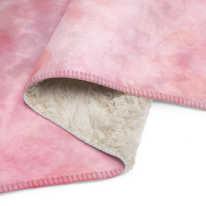 Close-up of a pink fleece blanket with a beige interior on a white background